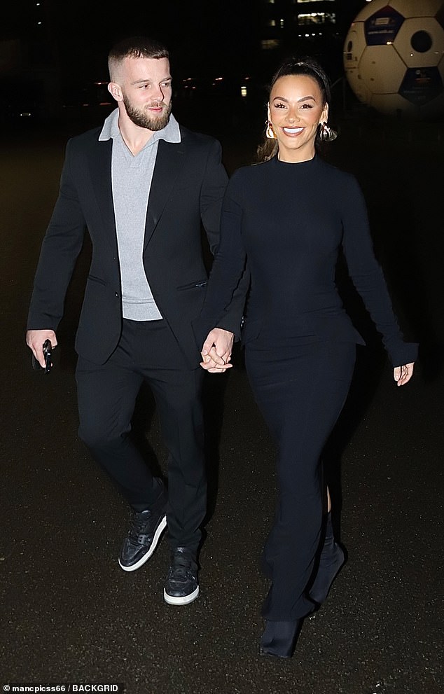 She styled her long locks into a high ponytail, revealing a pair of large chunky gold earrings as she walked hand in hand with her boyfriend Eddie.