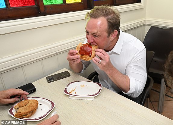 Queensland Prime Minister Steven Miles eats a pie at Yatala Pies in Yatala, Friday, October 25, 2024. The Queensland election will be held on October 26. (AAP Image/Darren England) NO ARCHIVING