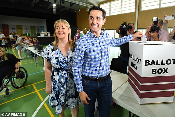 Opposition Leader David Crisafulli (right) and wife Tegan vote at Springwood State High school, during election day in Brisbane, Saturday, October 26, 2024. Queensland voters go to the polls to choose the state's next leader after an eventful, election campaign of four weeks. (AAP Image/Jono Searle) NO ARCHIVING