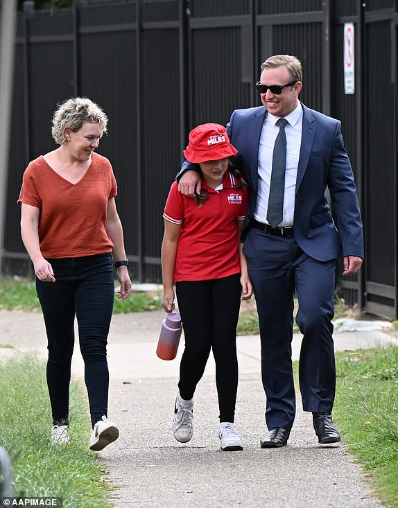 Queensland Premier Steven Miles, his wife Kim and daughter Bridie arrive to vote at Kallangur State School during election day in Brisbane, Saturday, October 26, 2024. Queensland voters go to the polls to choose the state's next leader after a eventful election day. , four-week election campaign. (AAP Image/Darren England) NO ARCHIVING