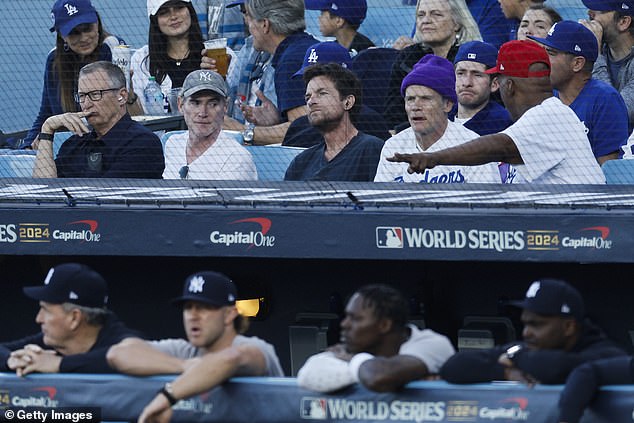 Actor Billy Crudup (second from left), Jason Bateman and musician Flea watch Game 1