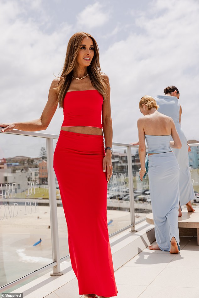 She showed off her toned abs in a strapless red crop top and a figure-hugging maxi skirt as she made sure all eyes were on her.