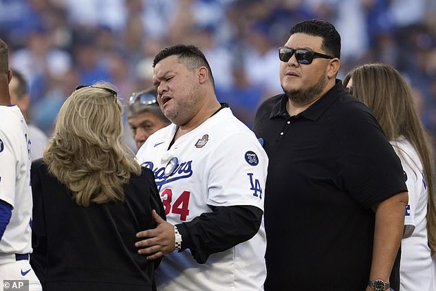 His wife Linda (left), sons Fernando Jr. (center) and Ricardo (right), and daughters Maria and Linda stood together on the home plate side prior to Game 1 of the World Series Friday