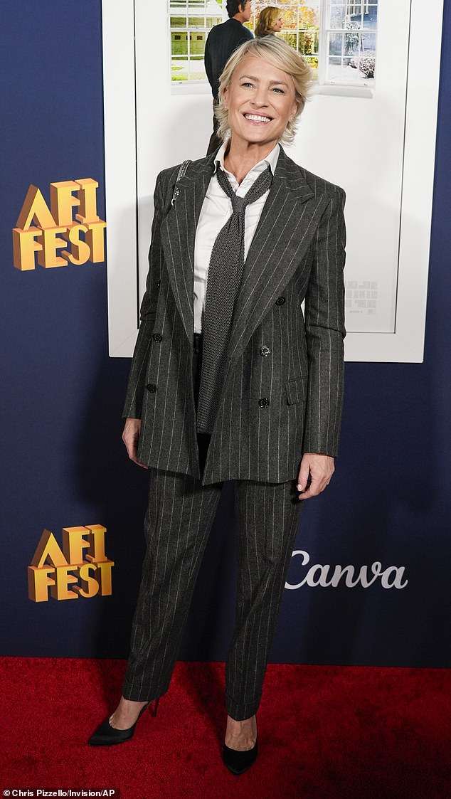 Wright, 58, opted for a black pinstripe suit and heels