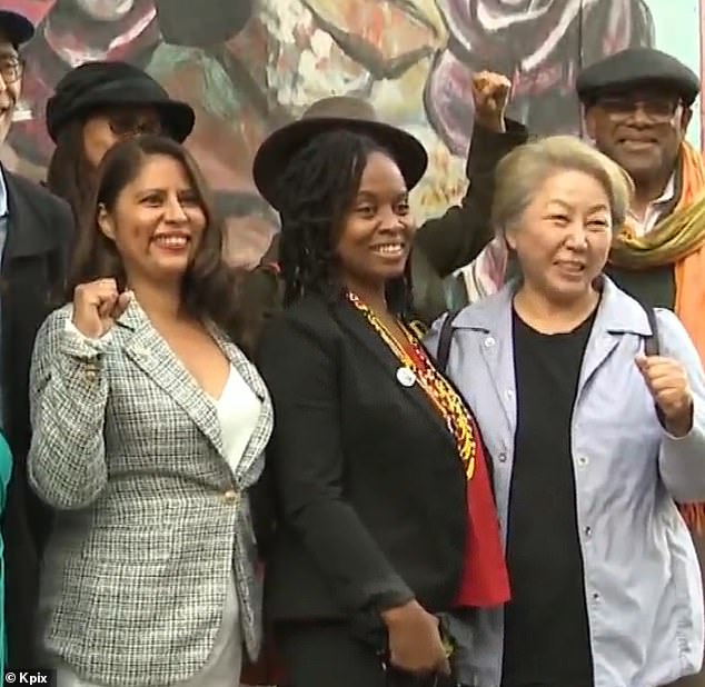 Fife is pictured in the center celebrating the passage of her legislation to dismantle the police in Oakland in 2021