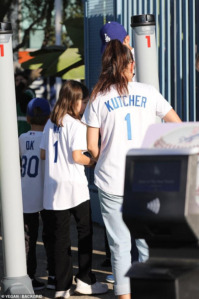 Unfazed by his celebrity status, Ashton was even spotted queuing to get snacks for the family