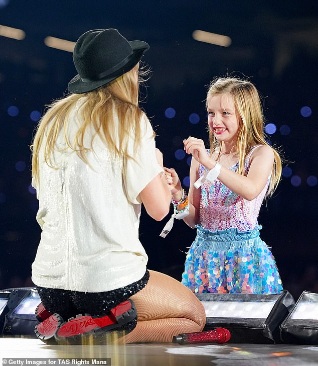 The Karma hitmaker and her fandom, called Swifties, stay connected through friendship bracelets. Taylor pictured with a happy fan Friday evening