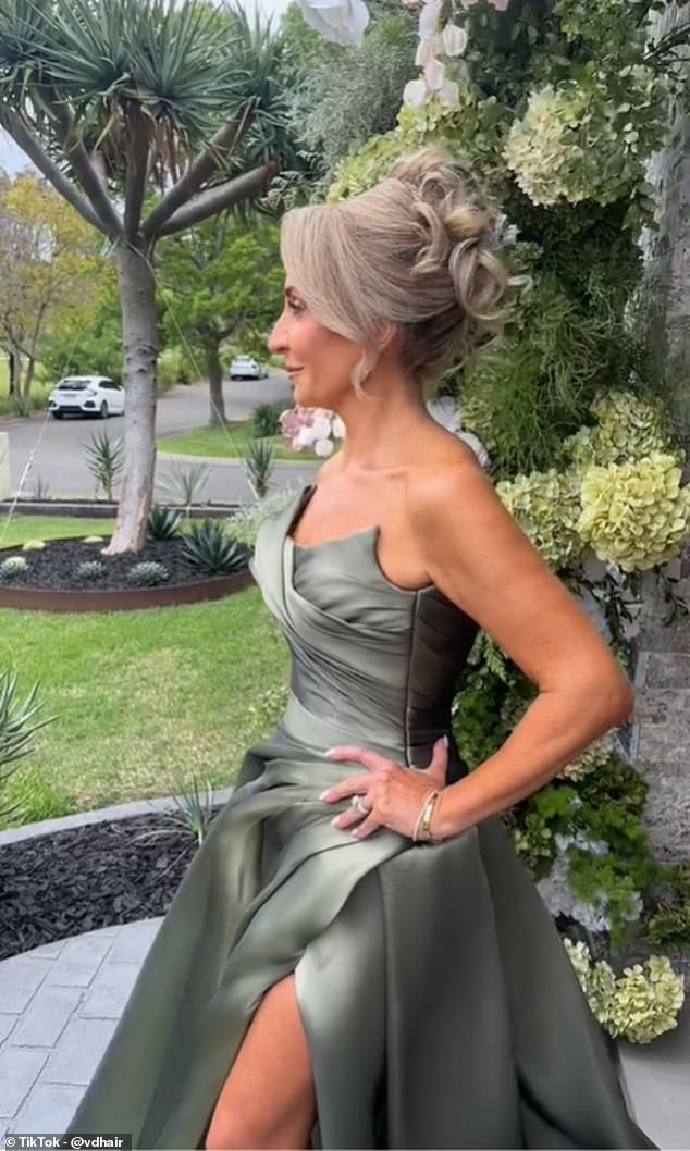 The mother of the bride confidently parades through her front lawn to show off the beautiful olive green dress, custom made by haute couture designer Georgina Marie