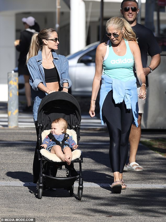 Lucy was seen pushing her daughter Robbie and chatting to her new mother-in-law Julie