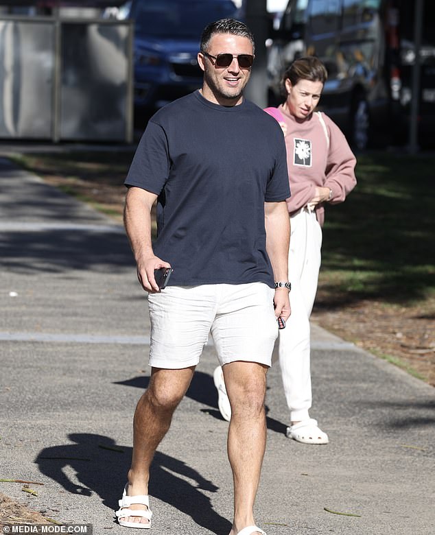 Sam looked comfortable in beige shorts paired with a black T-shirt, while he accessorized with sunglasses and off-white Birkenstock sandals