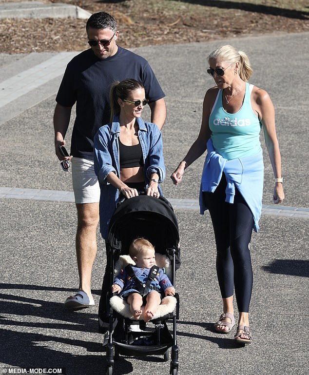 Sam's mom Julie echoed the activewear memo in a bright blue Adidas tank top and leggings