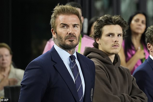 Cruz, 19, opted for a relaxed look in a dark brown hoodie as he enjoyed the match with his dad