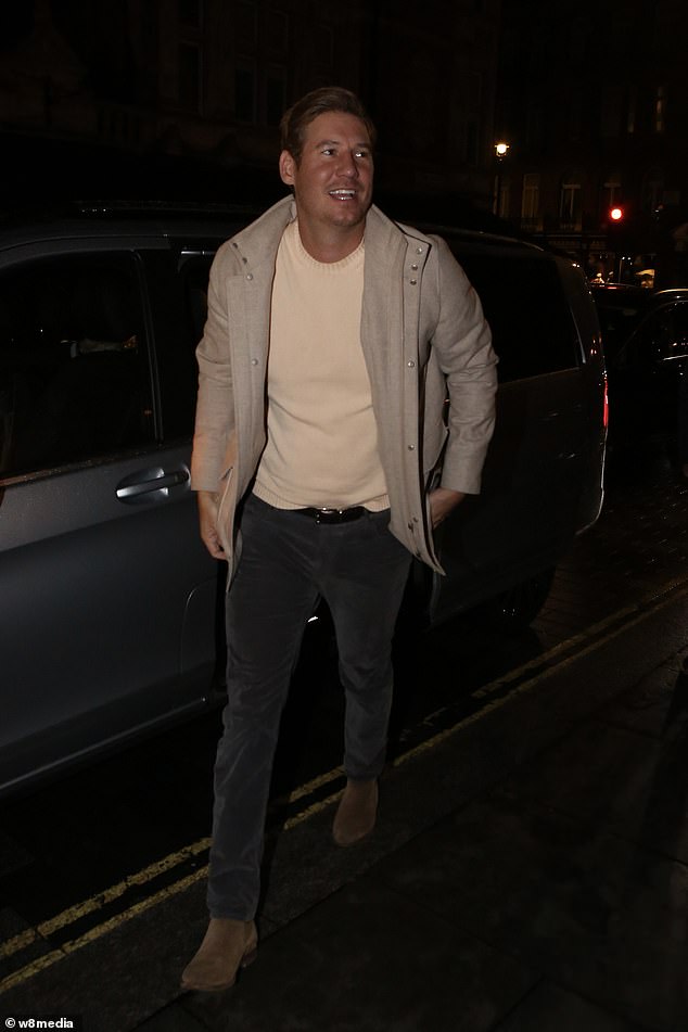 He teamed his ensemble with a pair of brown suede ankle boots and appeared cheerful as he stepped out of his car