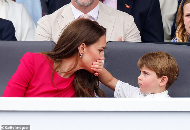 The four-year-old prince covers his mother's mouth as they both sit in the Royal Box on The Mall