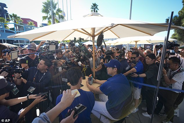 Ohtani is harassed by reporters prior to Game 1 of the World Series against the Yankees