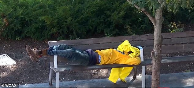 An apparently homeless man sleeps on a bench in downtown Burlington, Vermont's largest city.