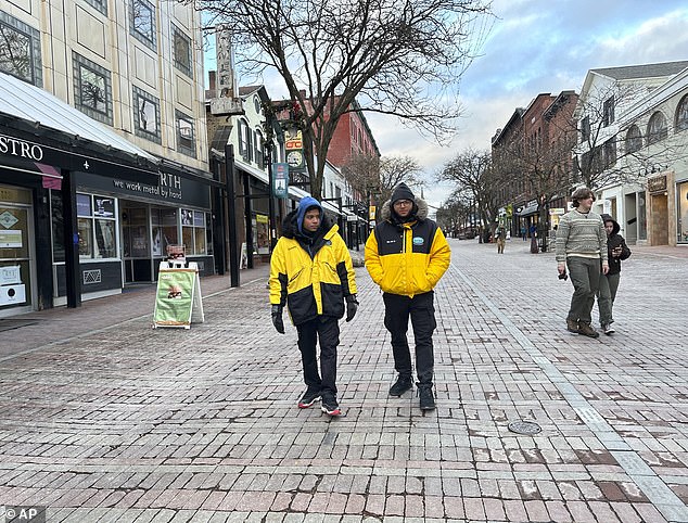 Two security guards walk the Church Street Marketplace in Burlington, which has increased security amid fears of drug activity, gun violence and shoplifting.