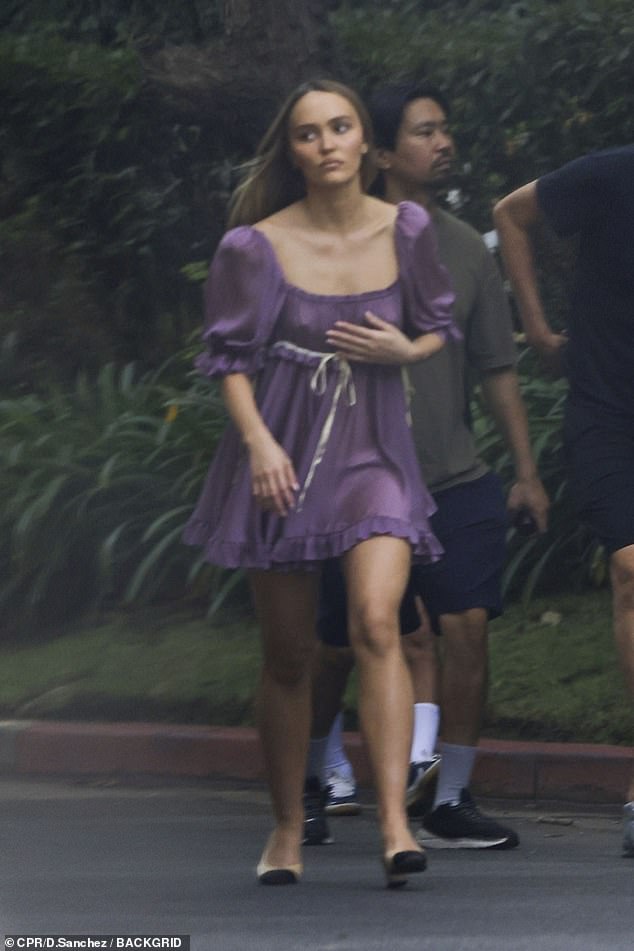 For a different look, Lily-Rose also wore a purple mini dress with a low-cut square neckline and short sleeves