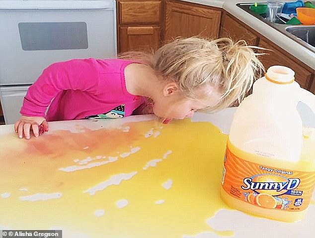 Tasty? Photos show what kids do when left to their own devices, including one little girl who poured half a tub of Sunny D on the table and, of course, started licking it