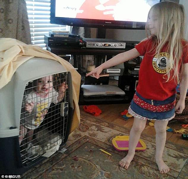 Time Out: A little girl appeared to have locked her sibling in a crate somehow, which seems better suited for pets than young children