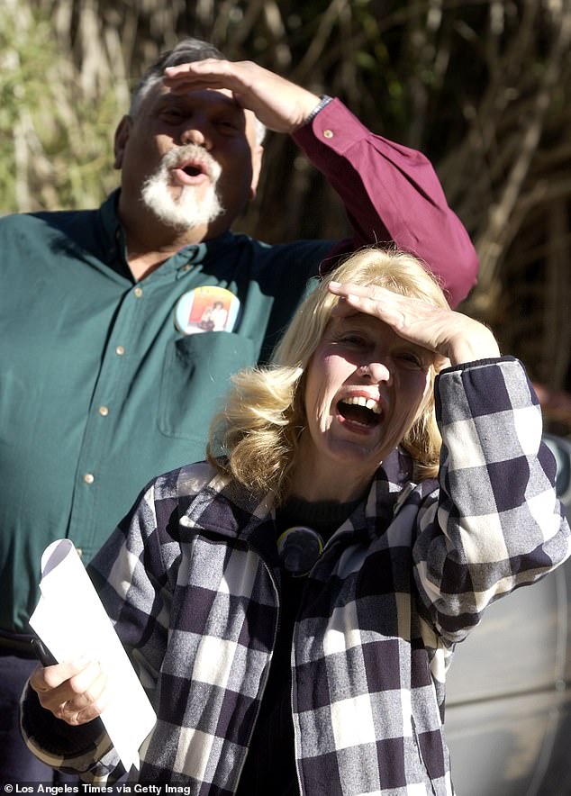 St. James Davis, left, and his wife La Donna Davis call out to Moe as they visit their adopted chimpanzee after he was removed from their West Covina home