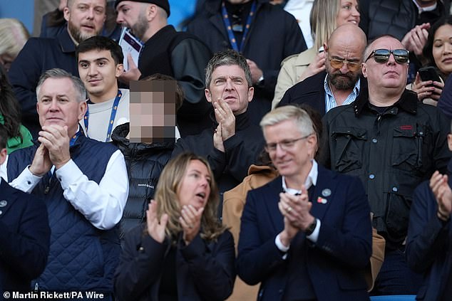 Noel wore a black button-down jacket as he watched his club take on The Saints and continue their bid to stay top of the table.