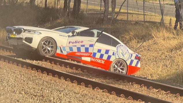 A NSW Police spokeswoman said officers are investigating how the incident occurred (photo of Highway Patrol car stranded on tracks near Mount Druitt station