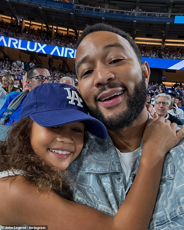 In another snap, his daughter lovingly wrapped her arms around her dad as the pair posed for a quick selfie together while sitting in the stands.