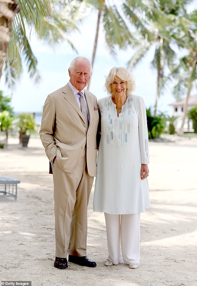 King Charles III and Queen Camilla smile while visiting a beach in Apia, Samoa