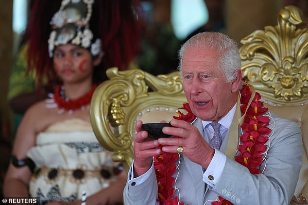 King Charles holds a bowl during a ceremony in Siumu Village, Samoa on October 26