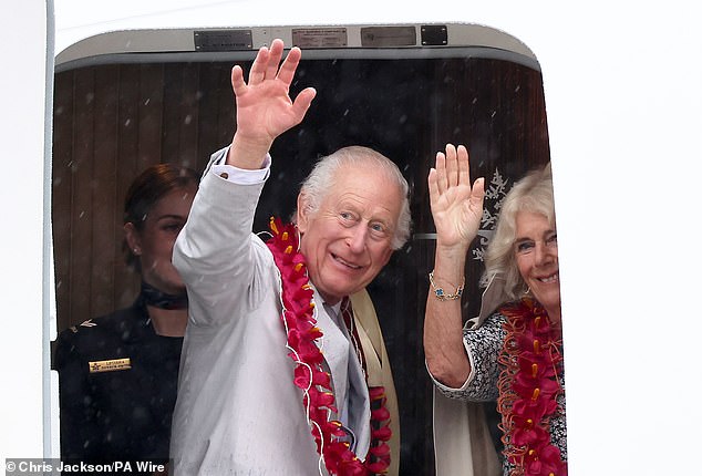 King Charles III and Queen Camilla wave as they board a Royal Australian Air Force plane before taking off from Faleolo International Airport in Samoa