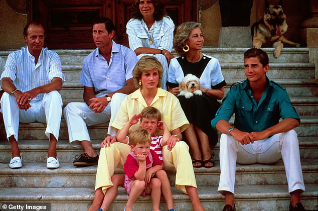 King Juan Carlos I of Spain, Prince Charles, Diana and William and Harry sit on the steps of Marivent Palace on August 10, 1987