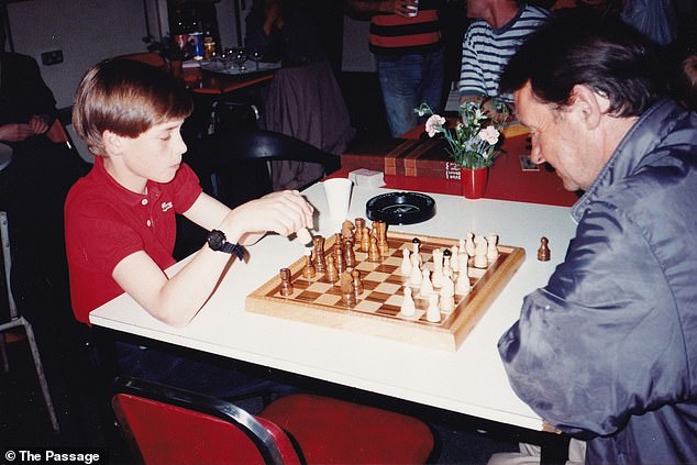 William, then 11 years old, can be seen handing out Christmas presents, playing a game of chess (pictured) and listening intently as his mother talks to people at the shelter