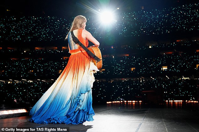 She unveiled the high-low V-neck dress with an orange bodice and a white and blue skirt as she serenaded her 83,000 screaming fans at the Caesars Superdome