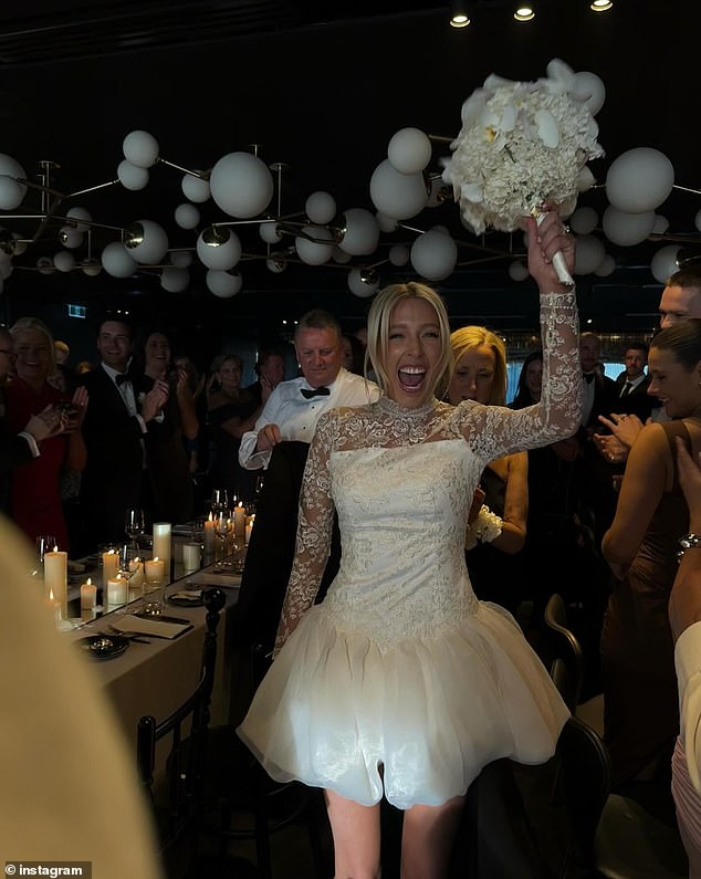 For the reception, the blushing bride switched to a less elaborate outfit, but kept a touch of sophistication with the lace sleeves and a short satin skirt.