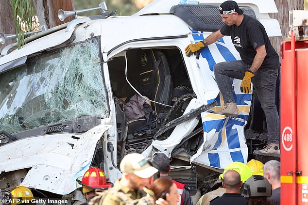 Israeli police inspect the body of the truck driver at the scene of a ram attack in Ramat Hasharon, north of Tel Aviv on October 27, 2024