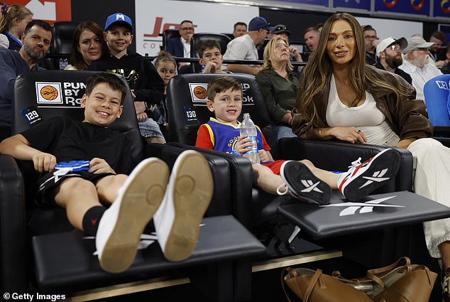 Nadia was every bit the doting mother as the boys got into the spirit with basketball equipment and hand clappers