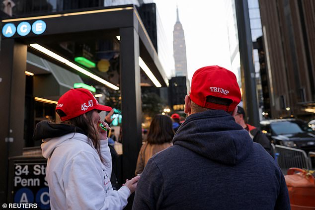 More Trump fans line up outside the arena wearing the iconic MAGA hats