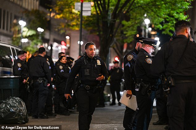 NYPD officers prepare for the large gathering early Sunday morning