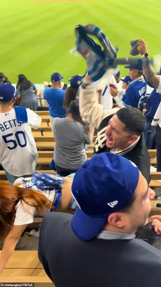 The fan shook and bumped into her partner in wild scenes at Dodger Stadium