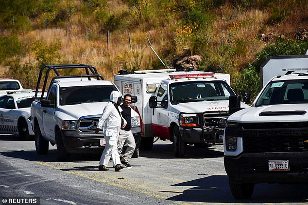 Authorities work at the scene of a passenger bus accident that killed several people and injured others while traveling on the highway from Nayarit to Chihuahua, in Piedra Gorda, Mexico, October 26