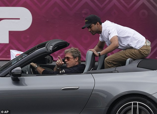 Brad was spotted during the drivers' parade in a steel gray sports car