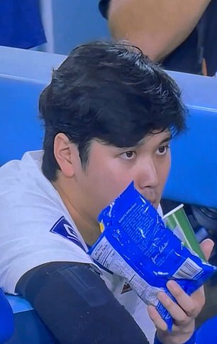 Ohtani spits into a cup after being offside