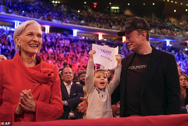 His son, whose full name is X Æ A-Xii, was also seen holding up a Trump Vance sign with his father's name on it.