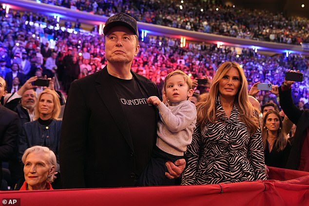 Musk holds his son and stands next to former First Lady Melania Trump, who took the stage in shock