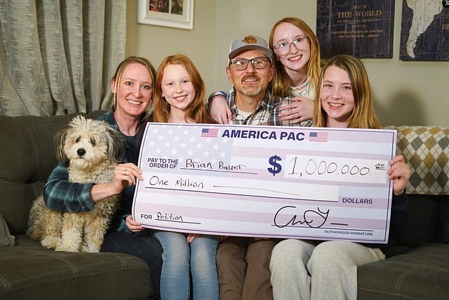 Brian Bauer posed next to his wife, three daughters and family dog ​​with the massive $1 million check. He was the last to win Musk's giveaway