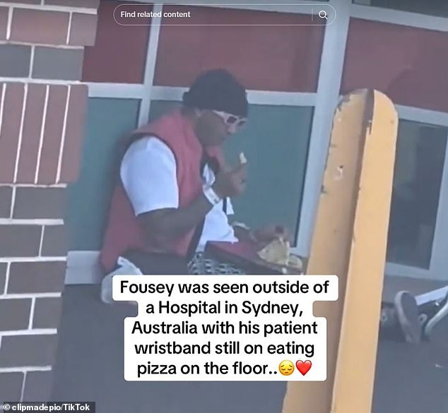 Fousey was later seen sitting on the floor outside Liverpool Hospital eating pizza