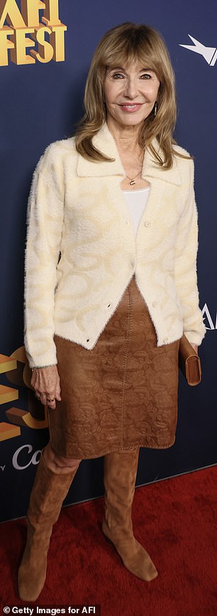 Steenburgen broke out her fall look in a brown suede skirt, a furry, tan top over a white T-shirt and dark brown, knee-high boots.