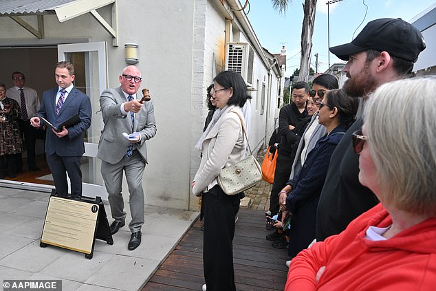 The woman responsible for setting interest rate policy has received a pay rise equivalent to an average Australian full-time salary (pictured from an auction in Sydney)