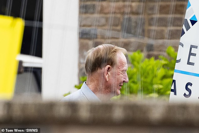 Mr Wildin photographed himself outside his home in July as demolition work continued on his man cave